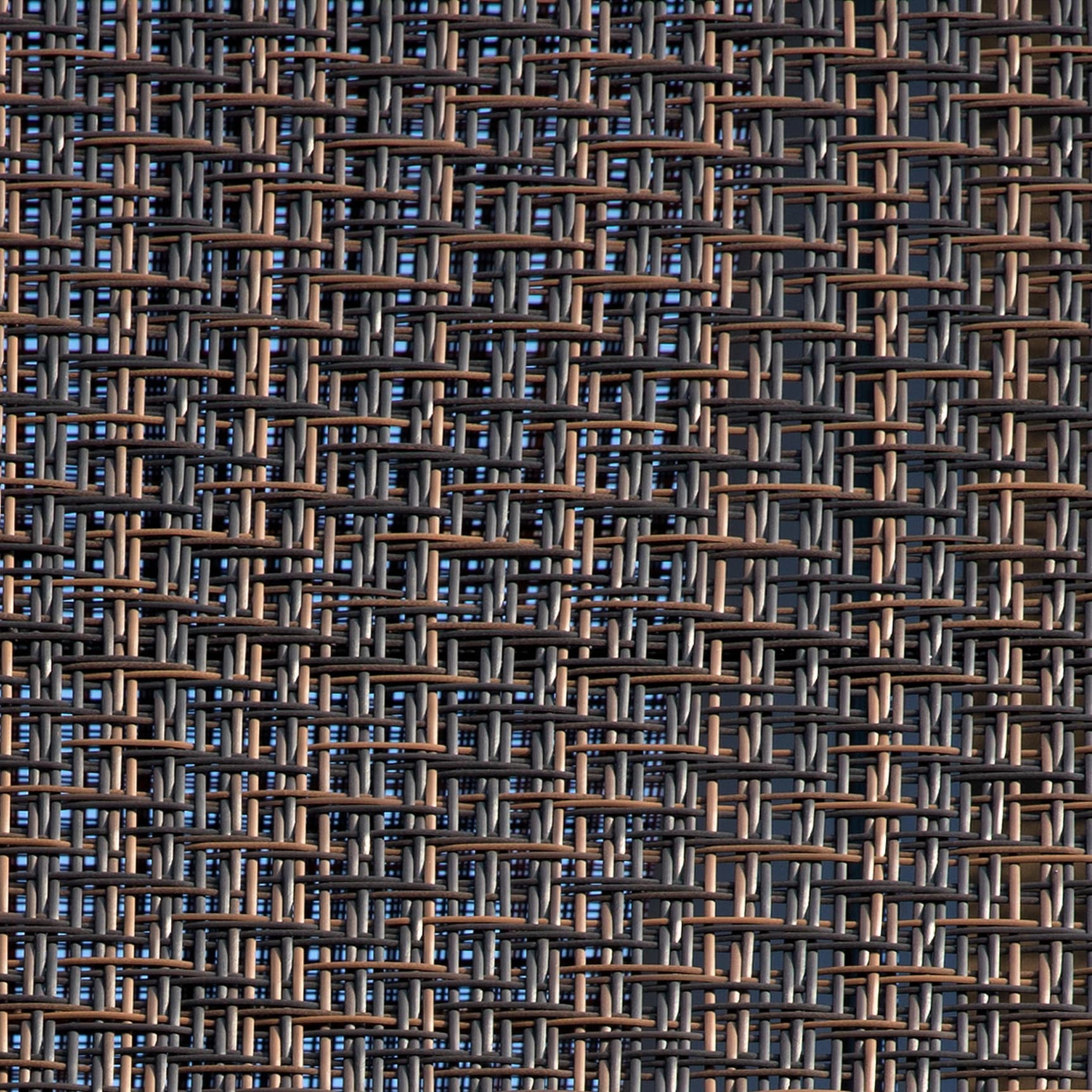 A layered weaving of staggered lines creates an irregular geometric rhythm, shifting between density and openness across the surface.